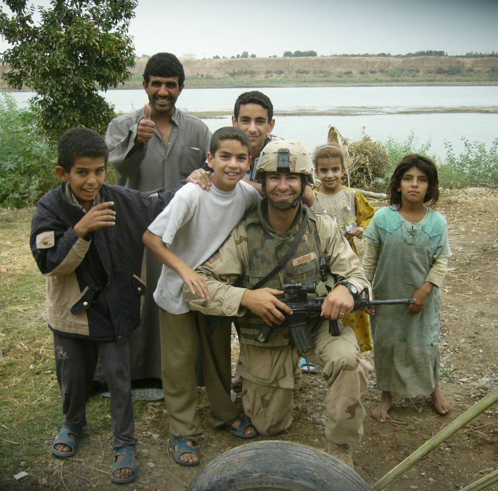 Shilo in his Army uniform with a local family